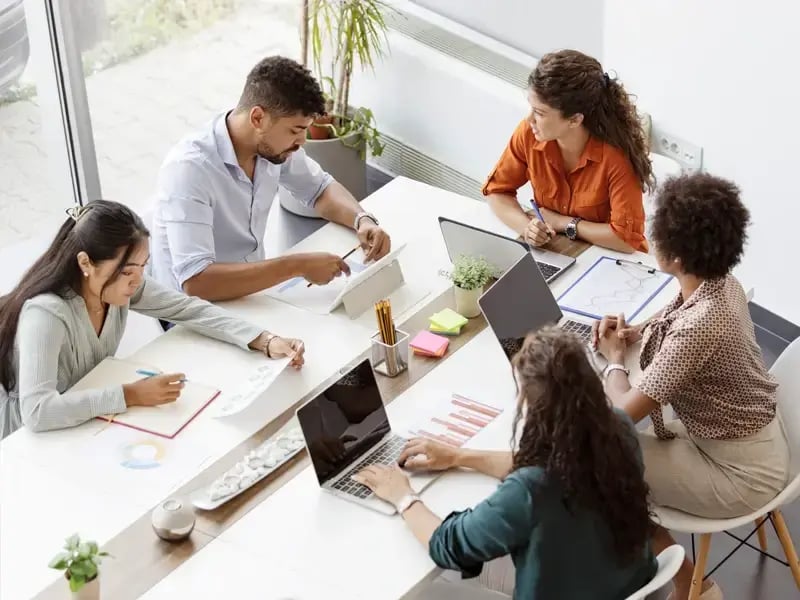 Paralegal sitting around a table at Kostelanetz LLP