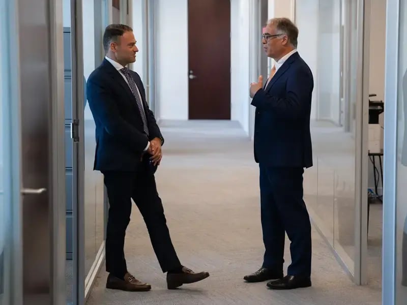 two layers speaking in hallway at Kostelanetz.